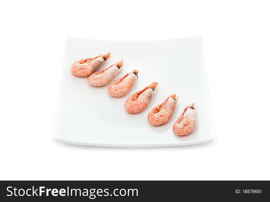 Row from fried prawns on plate. Isolated on white background. Row from fried prawns on plate. Isolated on white background