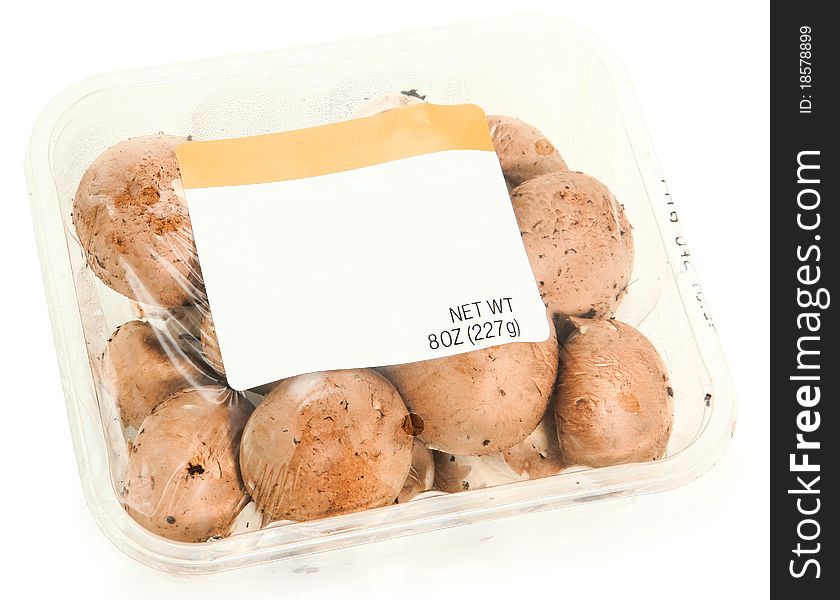 8 oz plastic grocery container of mushrooms with blank label for text. 8 oz plastic grocery container of mushrooms with blank label for text.