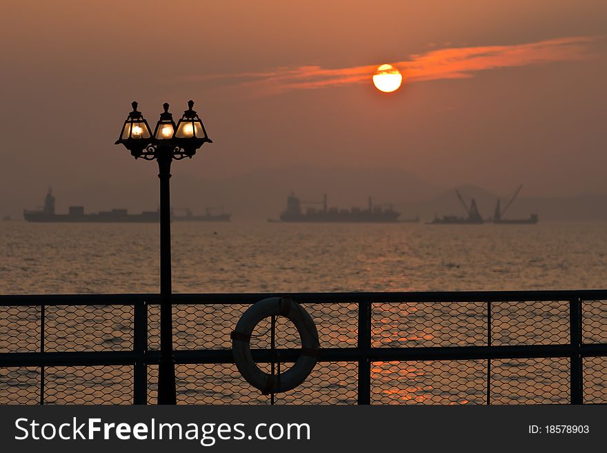 It is romantic sunset with lamppost.
