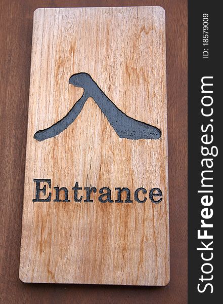Wooden entrance sign with Chinese and English
