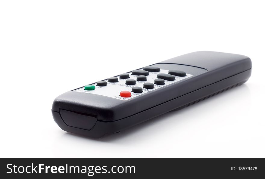Black controller from the TV to the power button, a white background, shallow depth of field. Black controller from the TV to the power button, a white background, shallow depth of field