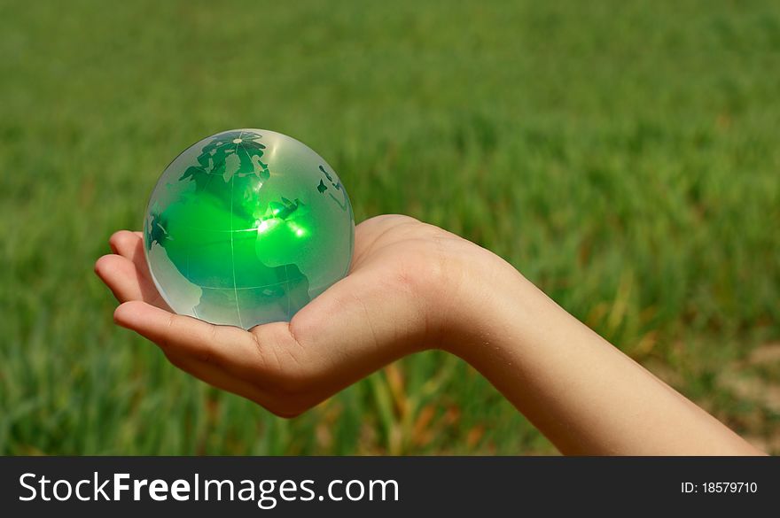 Glass ball in the hands of the planet