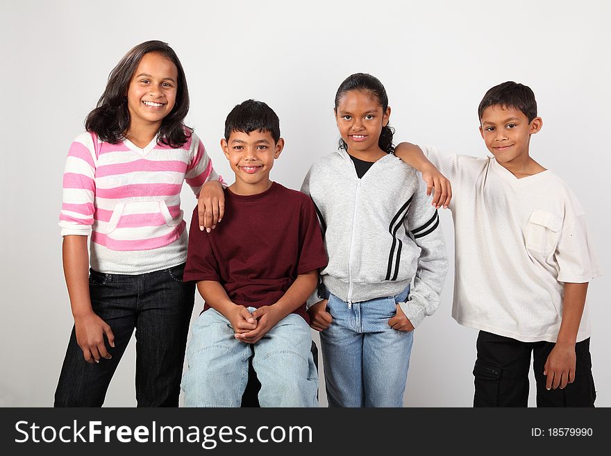 School friendship of four young happy, mixed race school children, two boys and two girls. School friendship of four young happy, mixed race school children, two boys and two girls.