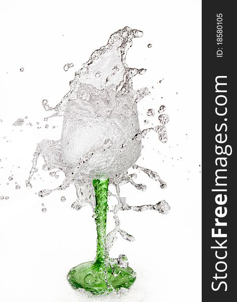 Water splashing out of a glass on white background