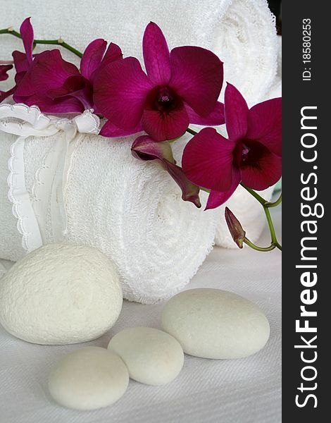 Still life with orchid, towel, pebble