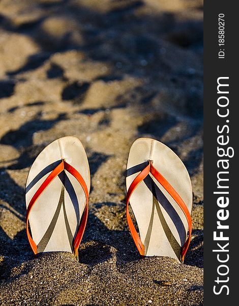 Flip flop on sandy beach in front of the sea. Flip flop on sandy beach in front of the sea