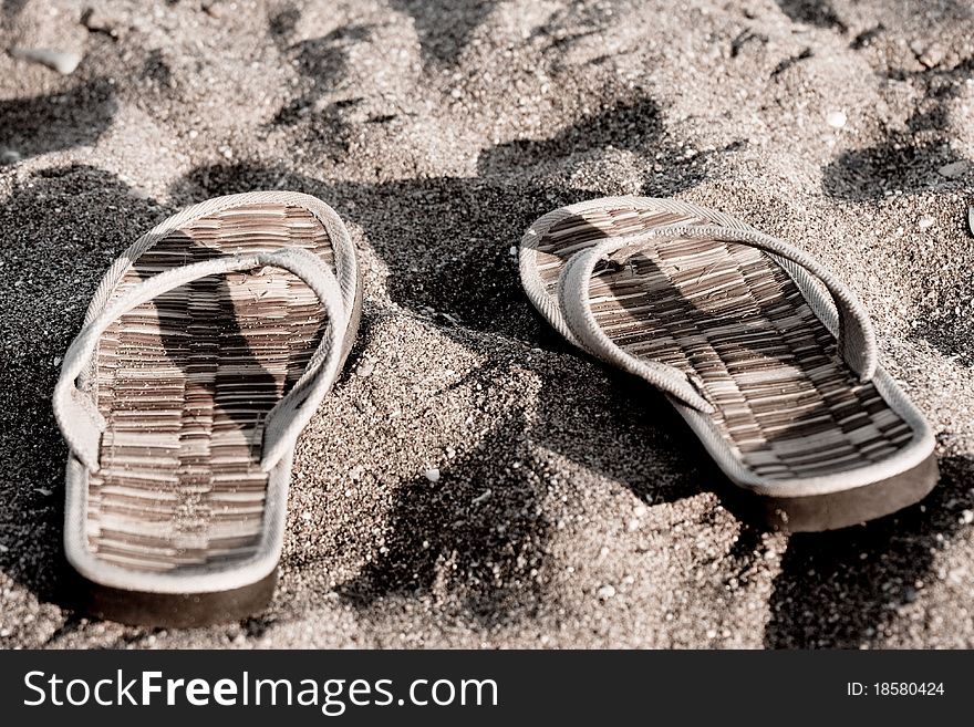 Flip flop on sandy beach in front of the sea retro look. Flip flop on sandy beach in front of the sea retro look