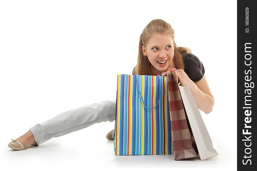 Young girl with purchases on white background