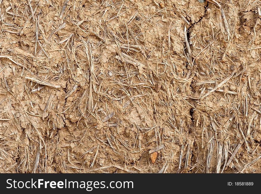 Old cracked wall made of orange clay and straw. Old cracked wall made of orange clay and straw