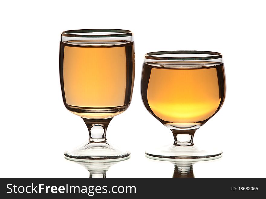 Glasses with alcohol. White background. Studio shot.