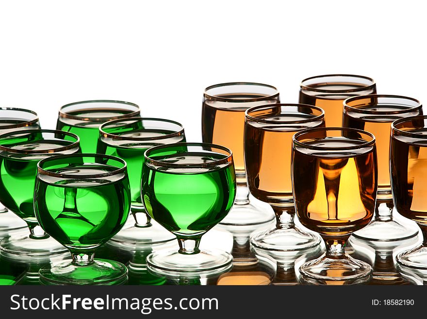 Glasses with alcohol. White background. Studio shot.