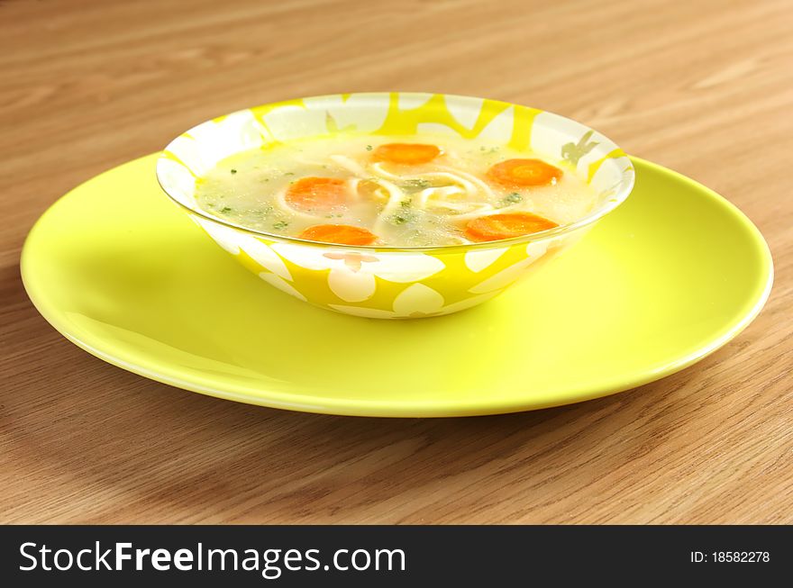 Soup with noodles in a dreen plate