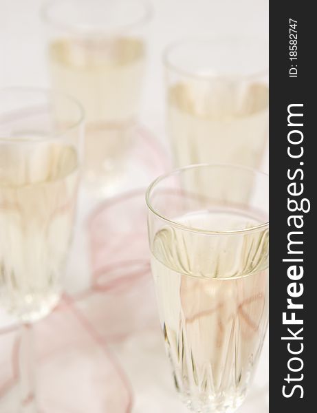 Close up of four filled champagne glasses