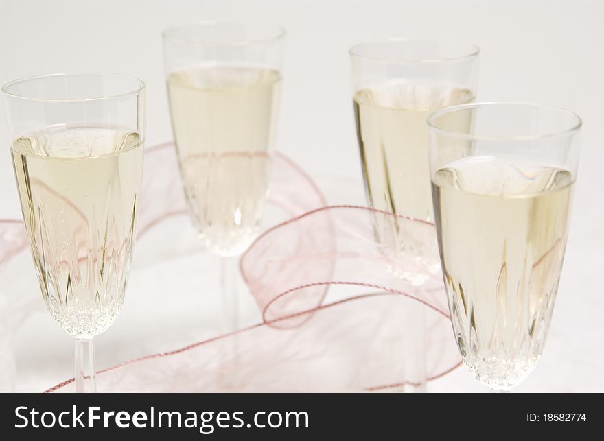 Close up of four filled champagne glasses