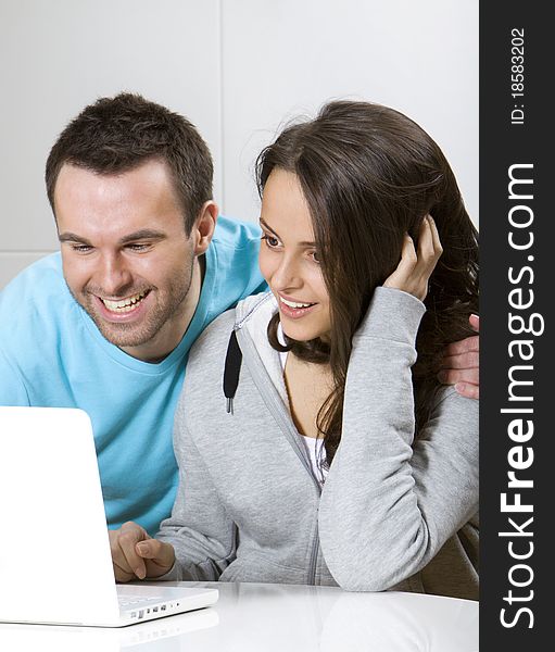 Happy young couple search in the internet. Happy young couple search in the internet