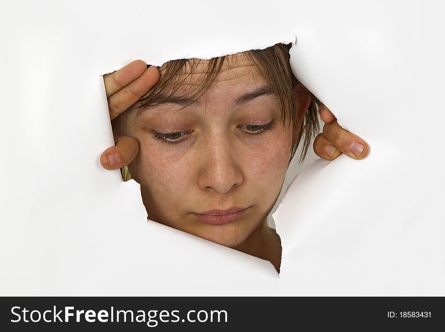 Young Woman is looking out of cutted paper.