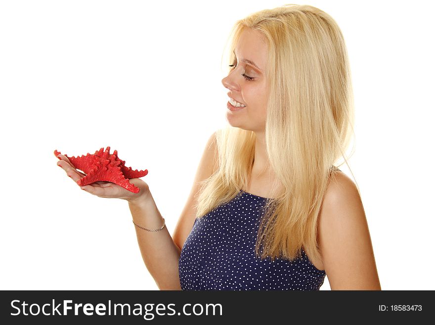 Close-up of an attractive young woman holding a red starfish. Remembers about the rest. Isolated on white. Close-up of an attractive young woman holding a red starfish. Remembers about the rest. Isolated on white