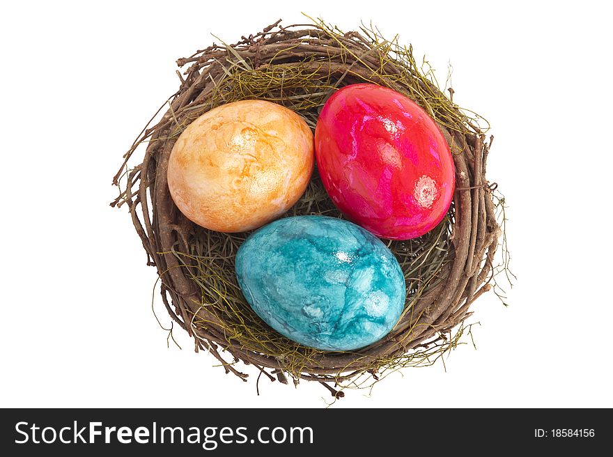 Easter nest with three colored eggs isolated on white background. Easter nest with three colored eggs isolated on white background