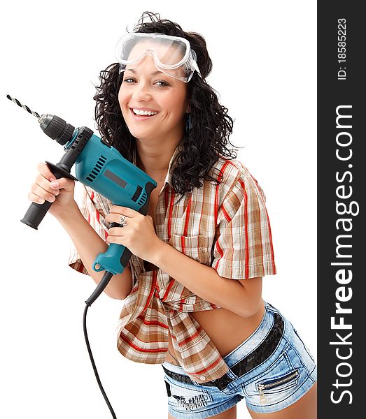 A young smiling female worker with a drilling machine. A young smiling female worker with a drilling machine