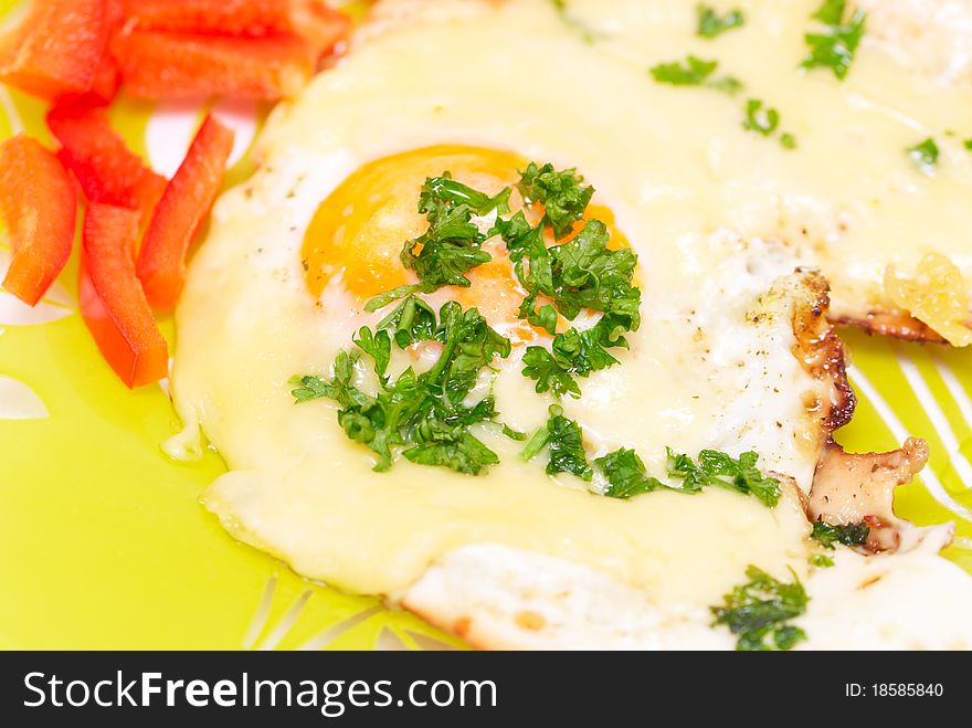 Fried egg with cheese adn red pepper on a plate