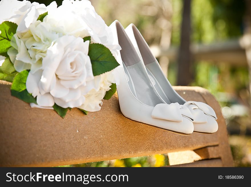 Bridal shoes and flowers on the bench. Bridal shoes and flowers on the bench