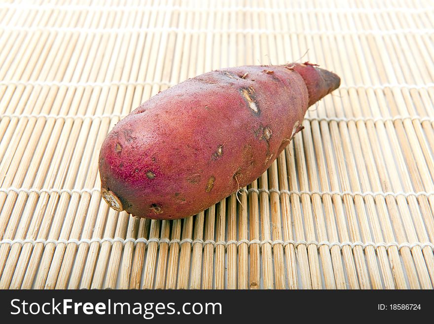 Sweet potato on sushi mat for use as background