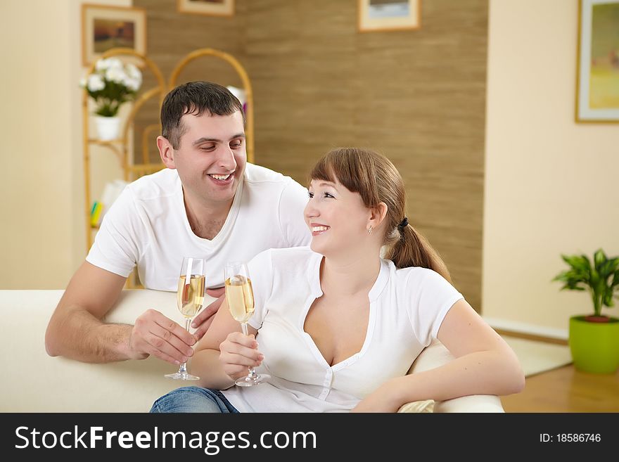 Couple at home drinking champagne