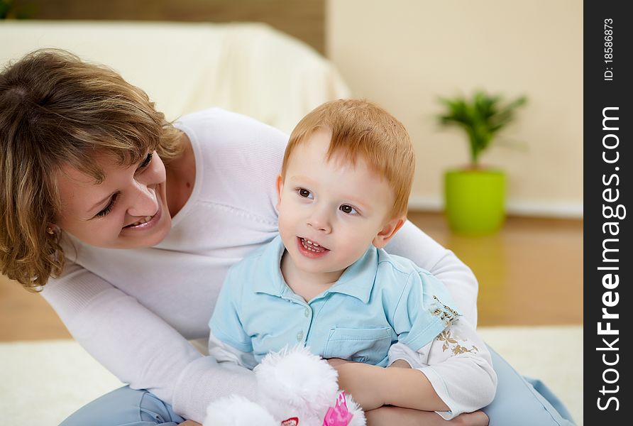 Mother And Son At Home On The Floor