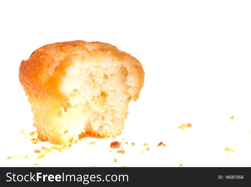 Bitten cup cake on white background.