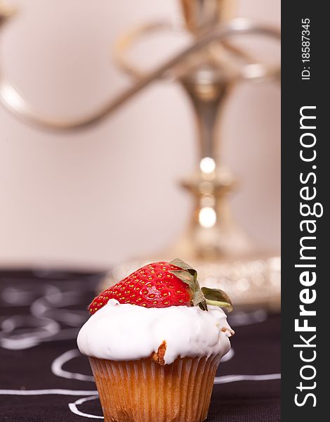 Cup cake decorated with strawberry on the table. Cup cake decorated with strawberry on the table.