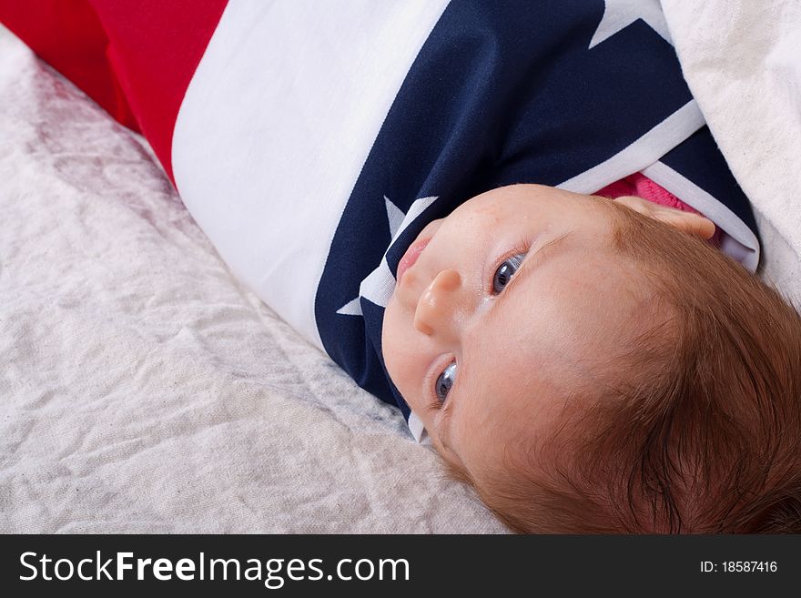 American baby wrapped and protected by the American Flag. American baby wrapped and protected by the American Flag.