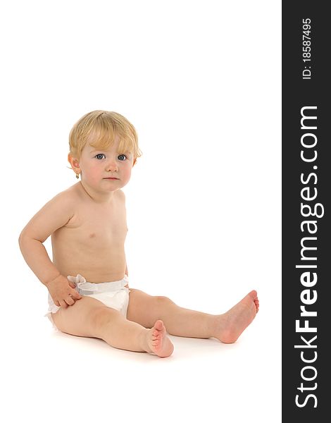 Baby sits, on white background.