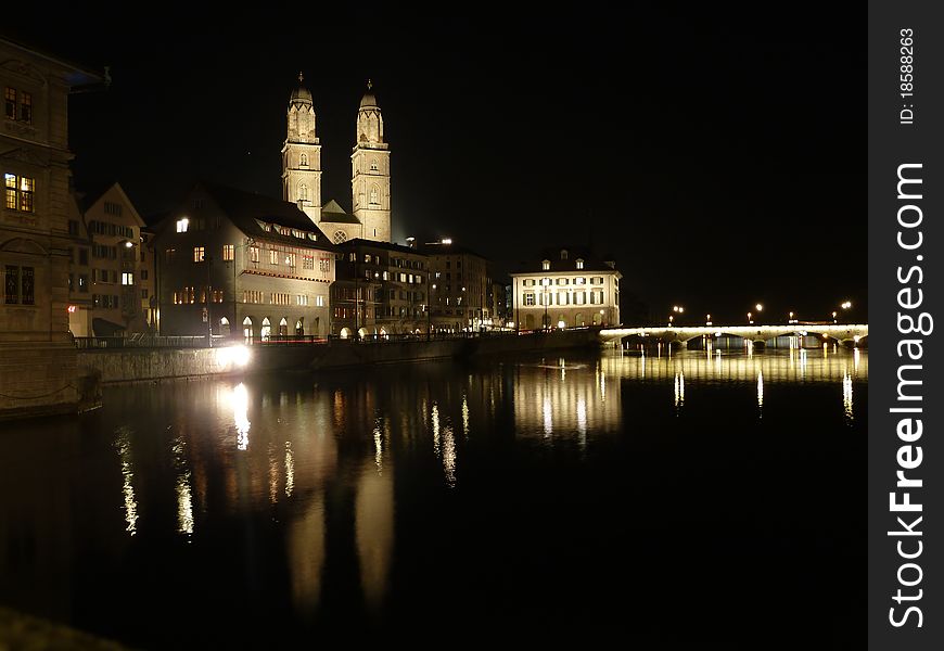 Switzerland, Zurich by night. Famous church Grossmunster and river Limmat. Switzerland, Zurich by night. Famous church Grossmunster and river Limmat.