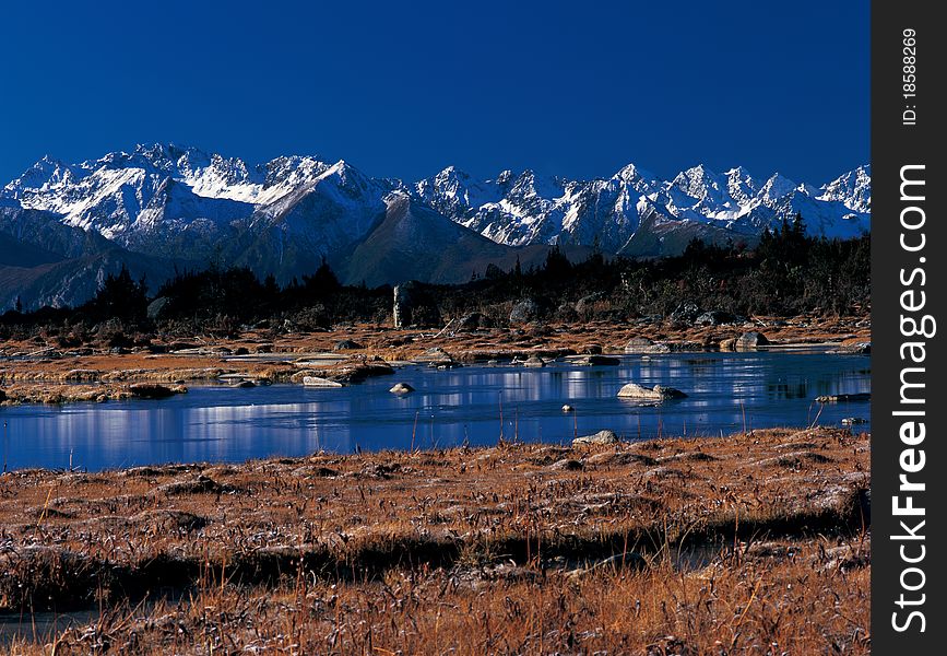 Snow mountain by the river, view in Tibet