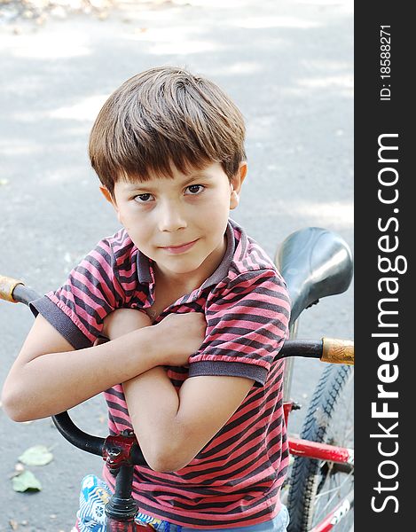 The Boy Sitting On A Bicycle