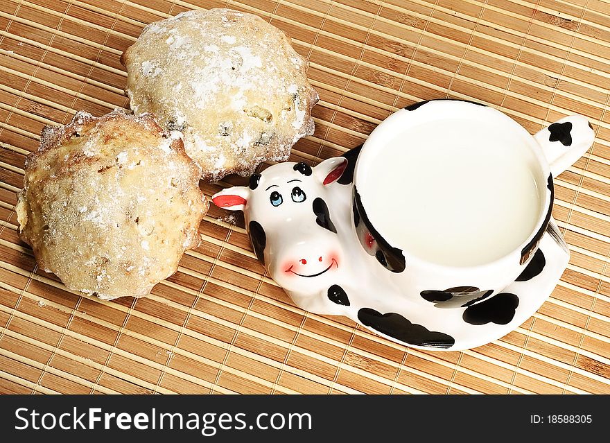 Cup With Milk And Tasty Fruitcakes