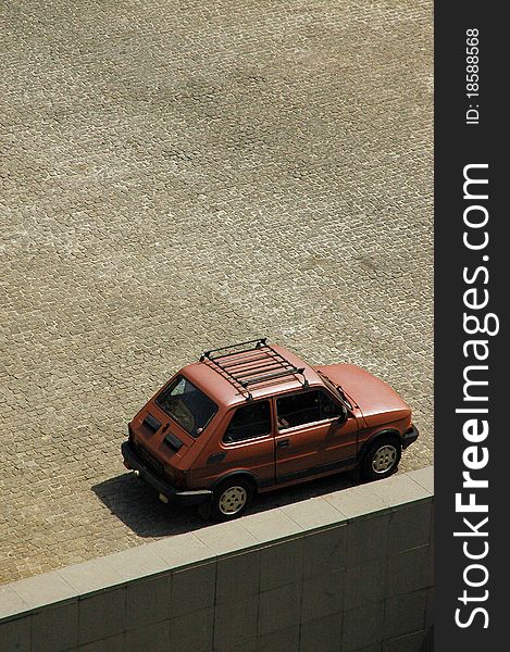 Small red polish car on granite paving. Small red polish car on granite paving