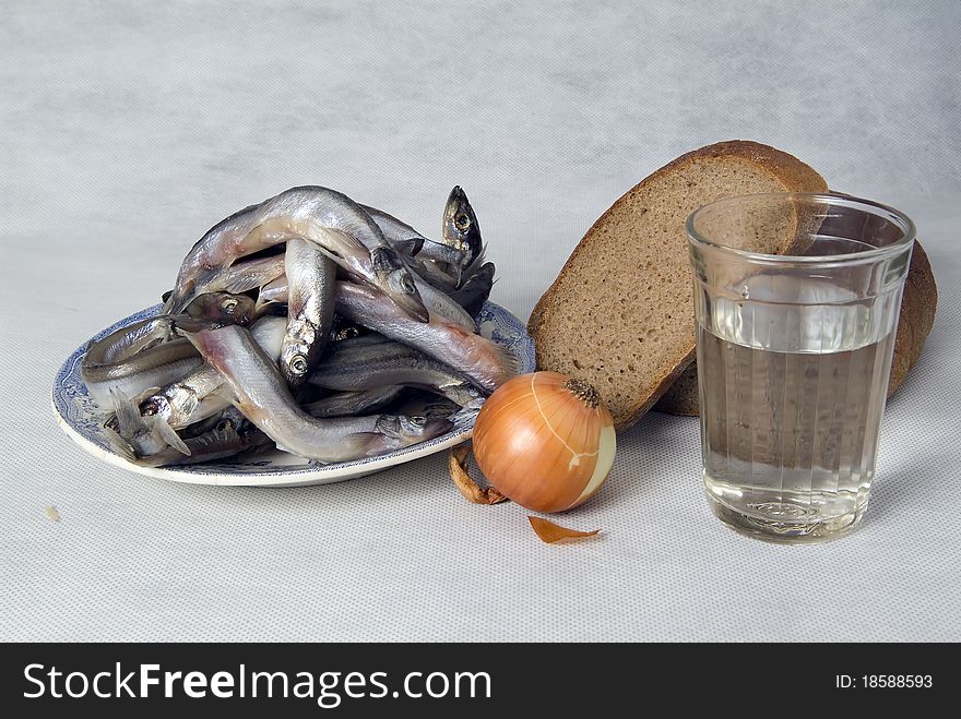 Still life with fish, bread and vegetables on white background