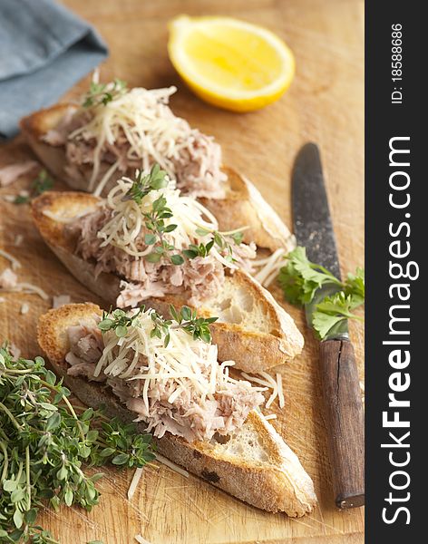 Toasted bread topped with tuna and grated cheese