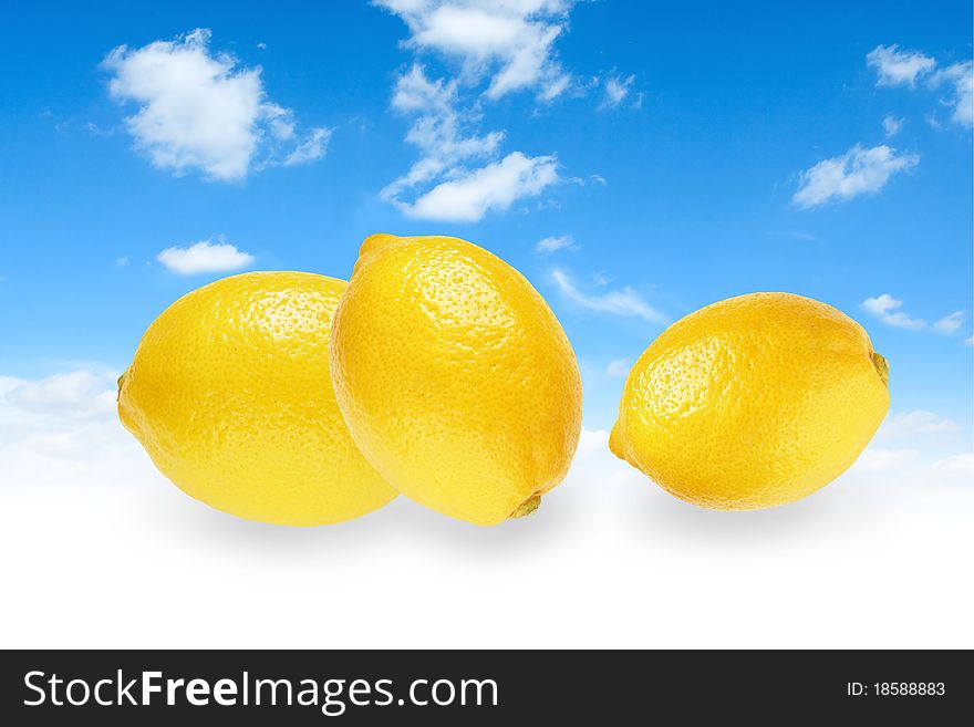 Blue sky with three yellow lemons