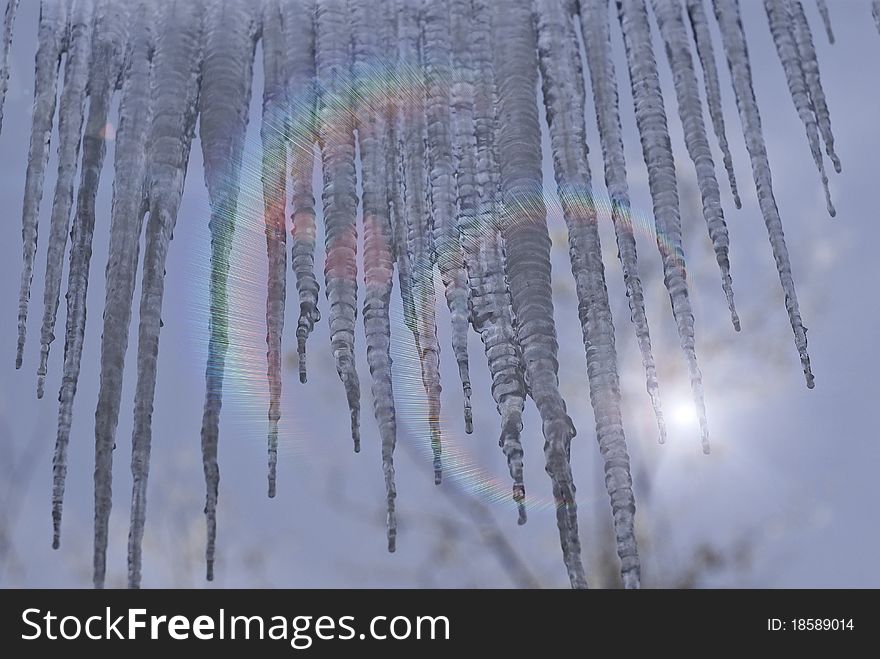 Icicles on a background of blue sunny sky. Icicles on a background of blue sunny sky.