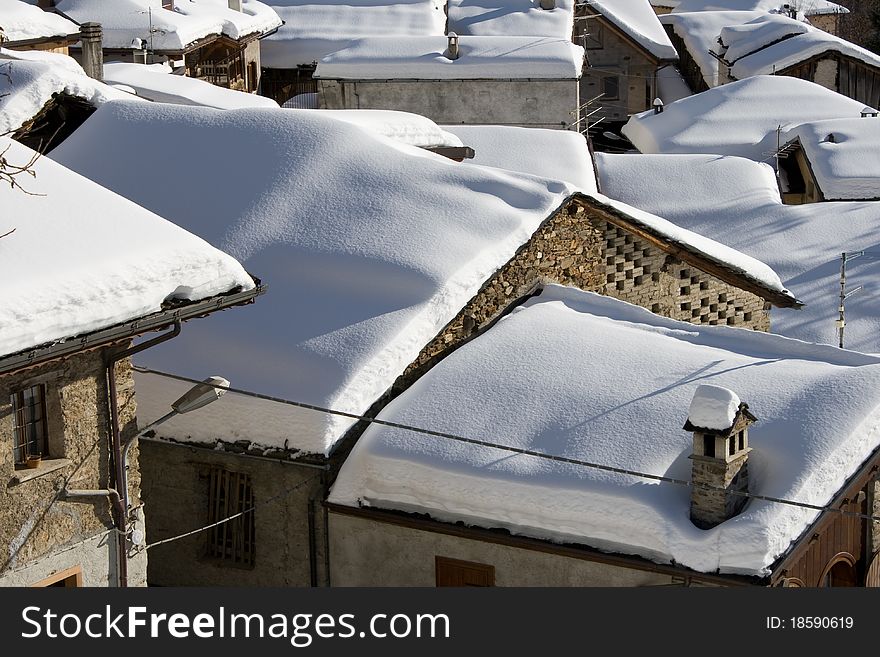 Snowy roofs in the little village of Pezzo (m. 1557). Valcamonica, Italian Alps. Snowy roofs in the little village of Pezzo (m. 1557). Valcamonica, Italian Alps.