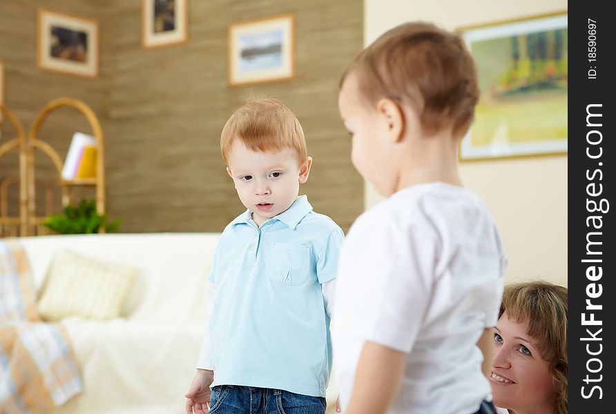 Two happy little boys playing together at home on the floor. Two happy little boys playing together at home on the floor