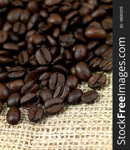 Fresh coffee beans on brown hessian bags