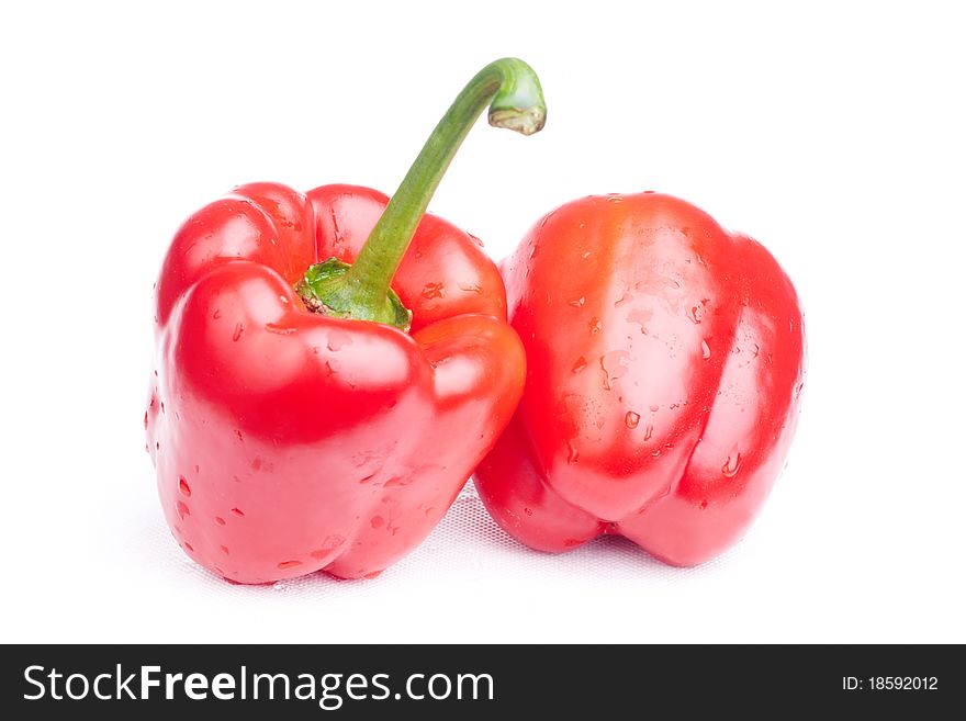 Two red peppers on white background - vertical shot