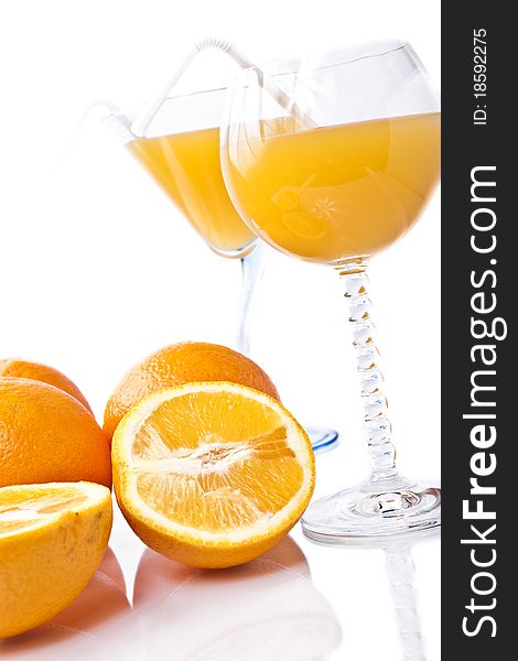 Wine glass of orange juice and fruit on a white background. Wine glass of orange juice and fruit on a white background