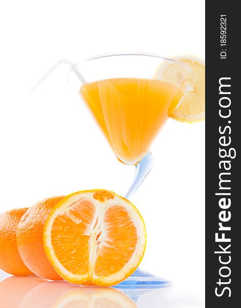 Wine glass of orange juice and fruit on a white background. Wine glass of orange juice and fruit on a white background