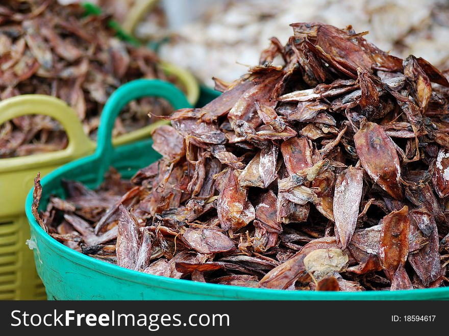 Dry squid in green basket at thailand