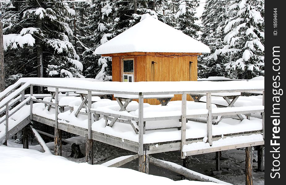 Wooden tables and benches for rest, concealed by snow-drifts, Carpathian Mountains, Dragobrat, Ukraine. Wooden tables and benches for rest, concealed by snow-drifts, Carpathian Mountains, Dragobrat, Ukraine