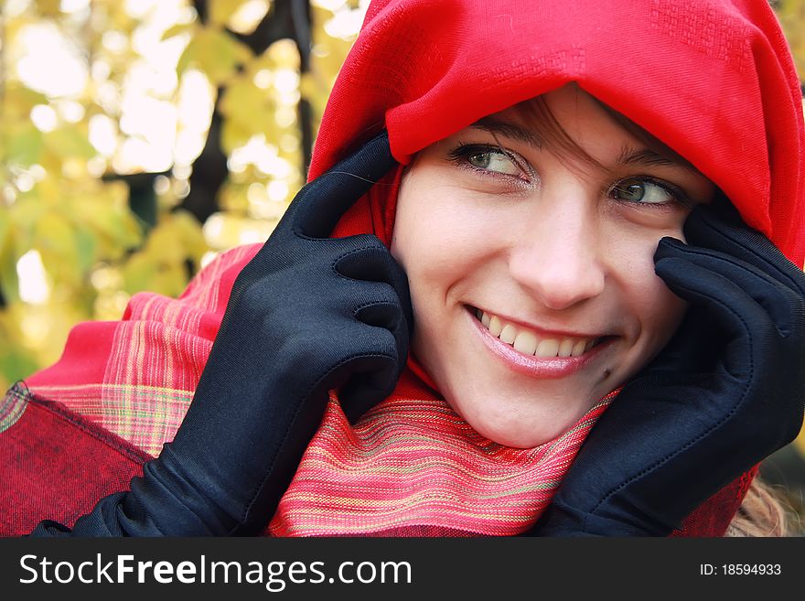 Closeup portrait of young beautiful girl in a red scarf. Closeup portrait of young beautiful girl in a red scarf